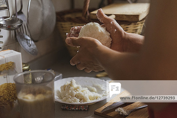 Hands preparing a mix with flour
