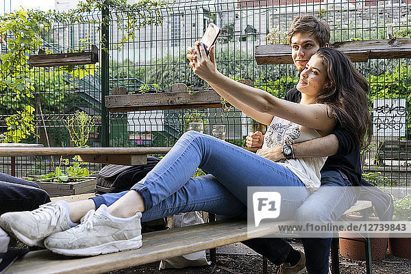 Young couple taking a selfie at an outdoor bar