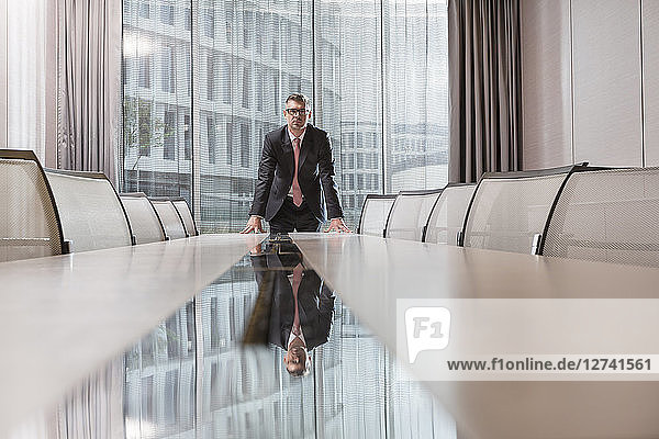 Poland  Warzawa  businessman standing at conference table in hotel