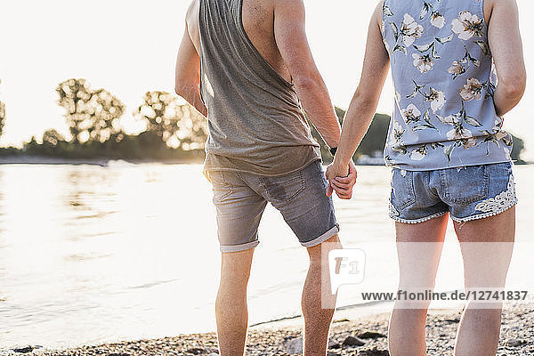 Young couple walking at the riverbank