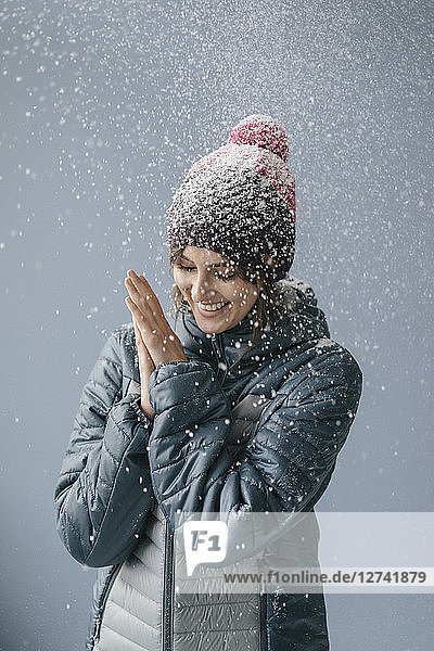 Woman wearing woolly hat in snow  portrait
