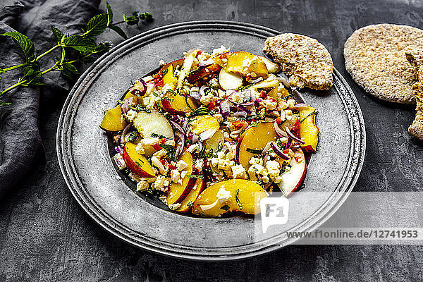 Salad with peaches  feta and mint served with pita bread