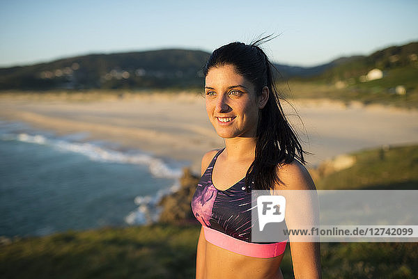 Portrait of an athlete woman in the evening  beach in the background