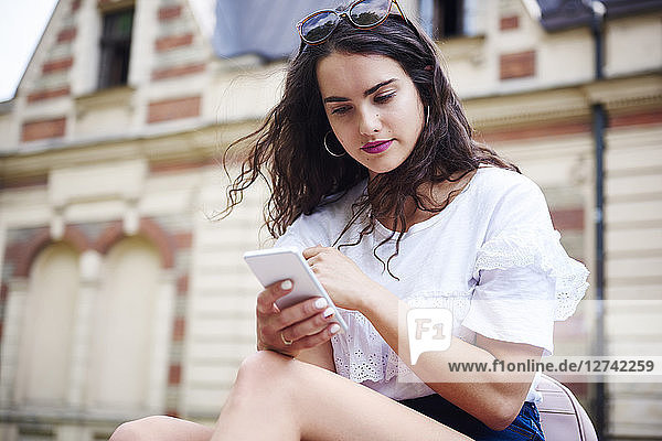 Portrait of young woman using cell phone outdoors