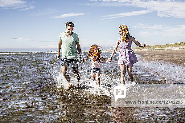 Netherlands  Zandvoort  happy family splashing in the sea
