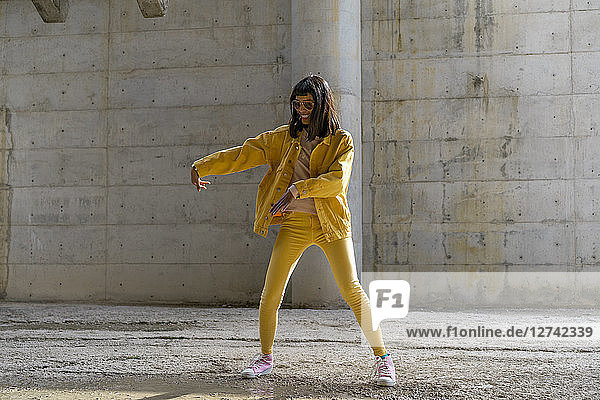 Woman wearing yellow jeans clothes,  dancing