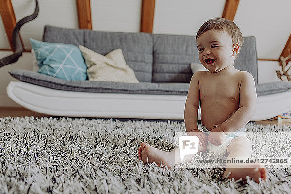 Happy baby playing on carpet