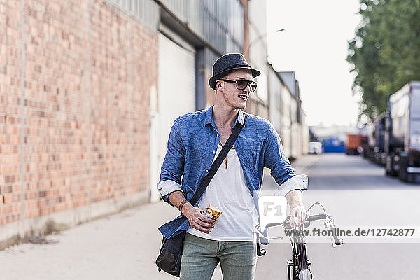 Young man with bicycle on the street