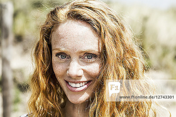 Portrait of smiling redheaded woman