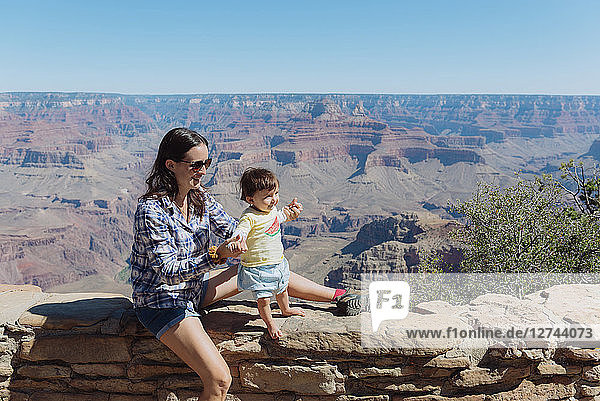 USA  Arizona  Grand Canyon National Park  Grand Canyon Village  mother and little daughter on a wall