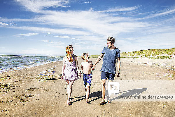 Netherlands  Zandvoort  happy family walking on the beach