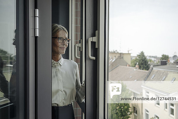 Businesswoman in office looking out of window