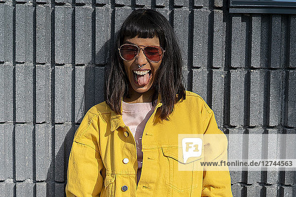 Portrait of young woman  wearing yellow jeans jacket