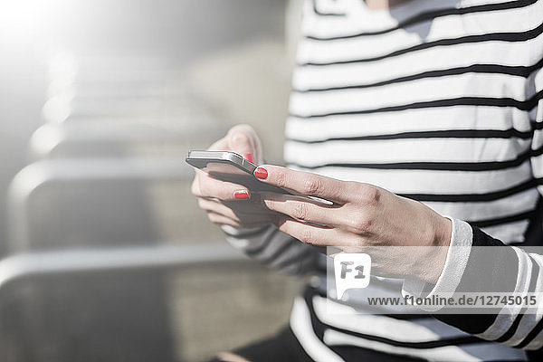 Woman's hands using cell phone  close-up
