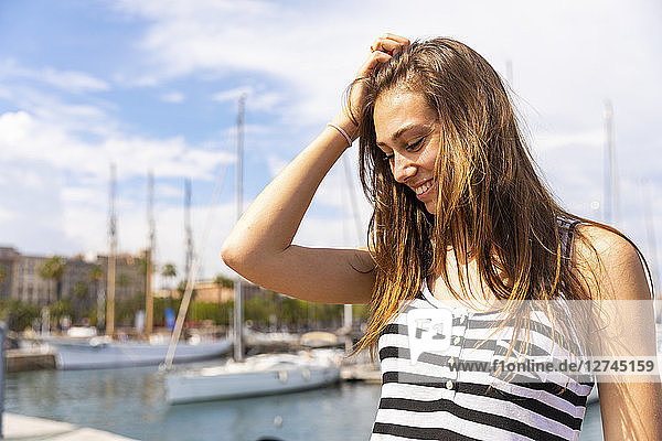 Smiling young woman at a marina