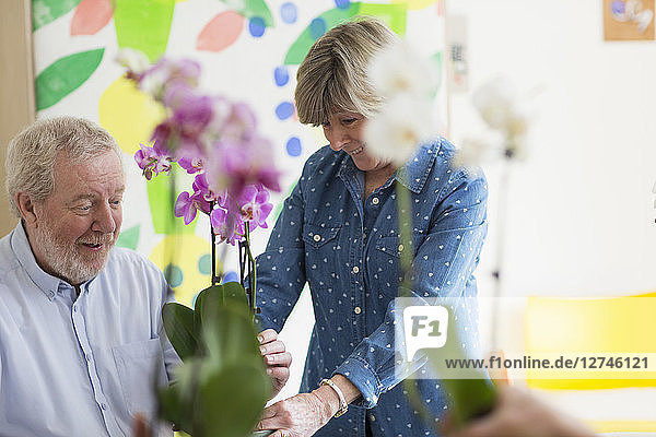 Active senior couple enjoying flower arranging class