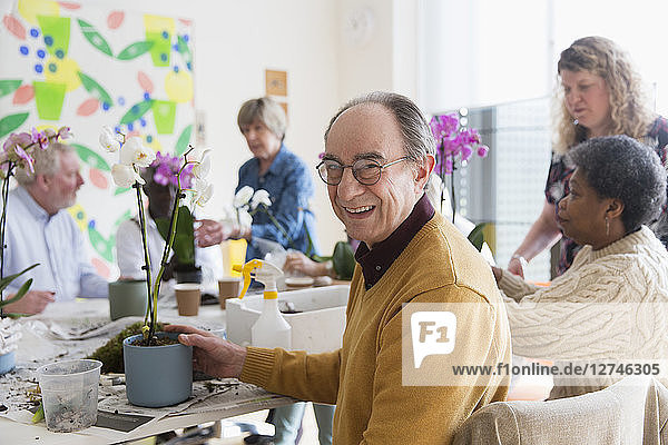 Portrait smiling  confident active senior man enjoying flower arranging class