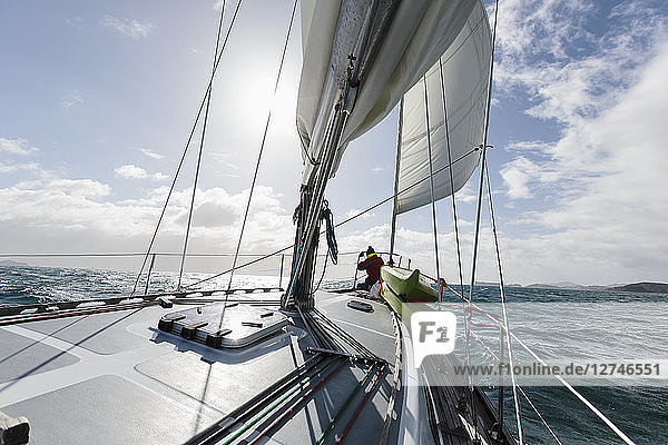 Woman at bow of sailboat on sunny ocean  Vava'u  Tonga  Pacific Ocean