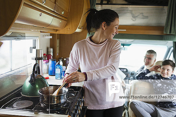 Mother cooking for family in motor home