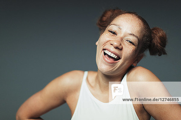 Portrait carefree woman with freckles laughing