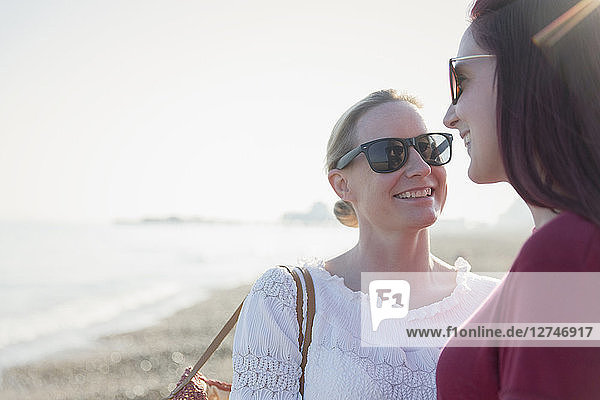 Affectionate lesbian couple on sunny beach