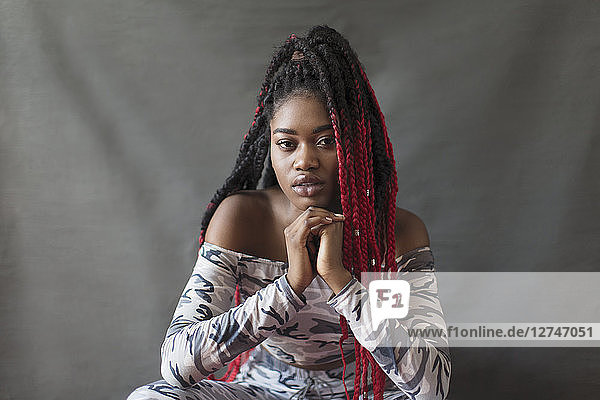 Portrait confident  cool young woman with red braids