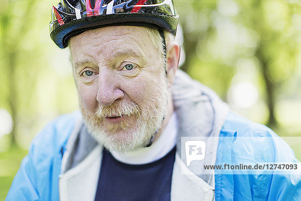 Portrait confident active senior man wearing bicycle helmet