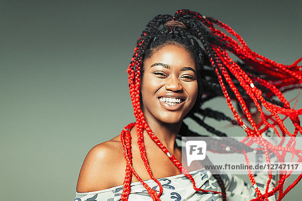 Portrait confident  carefree young woman with red braids