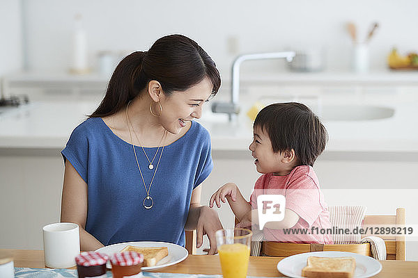 Japanese mother and kid having breakfast