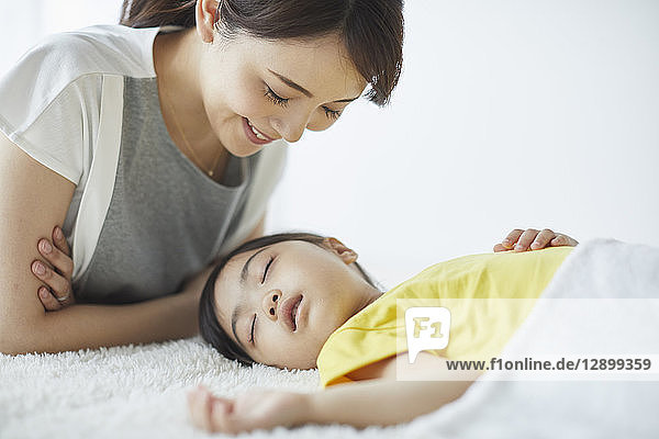 Japanese mother with sleeping kid