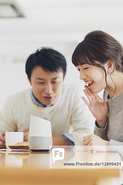 Japanese couple in the kitchen with smart home assistant