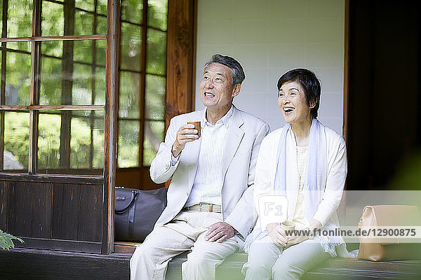 Japanese senior couple having fun at traditional inn