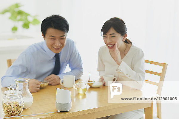 Japanese couple in the kitchen with smart home assistant