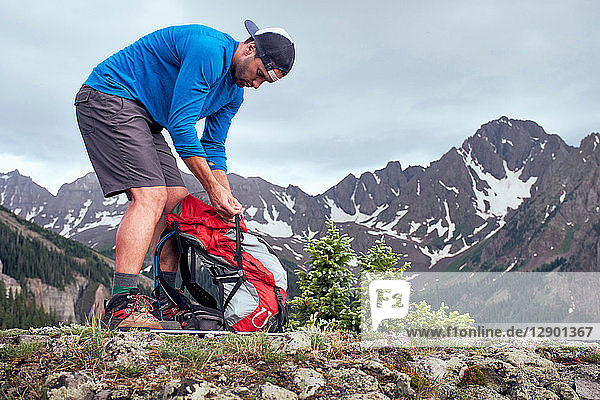 Hiker taking break  Mount Sneffels  Ouray  Colorado  USA