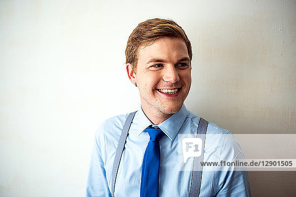 Businessman wearing braces and tie