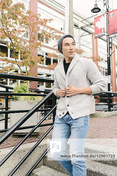 Young man walking down stairs  Yaletown  Vancouver  Canada