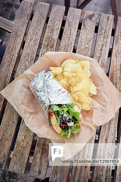 Meal of salad wrap and potato chips