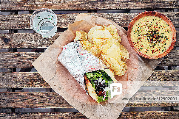 Meal of salad wrap potato chips and dip