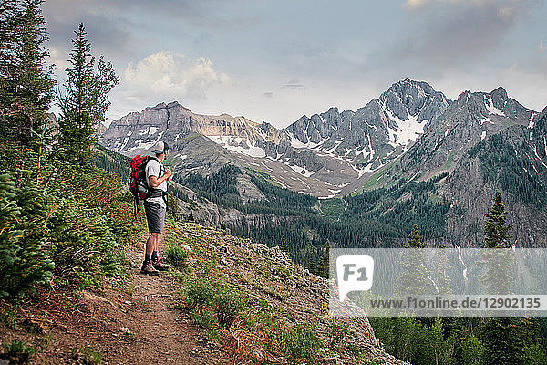 Hiker on mountain peak  Mount Sneffels  Ouray  Colorado  USA