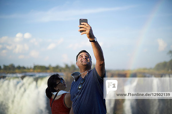 Tourists taking selfie  Victoria Falls  Zimbabwe
