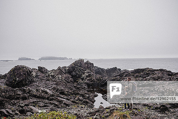 Father and child walking on rocks  Tofino  Canada