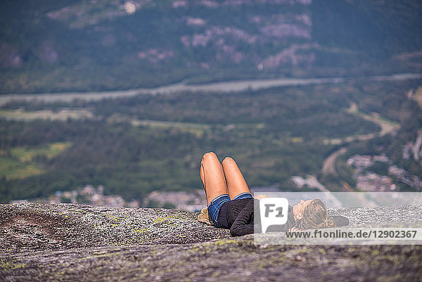 Rock climber relaxing at top of rock  Squamish  Canada