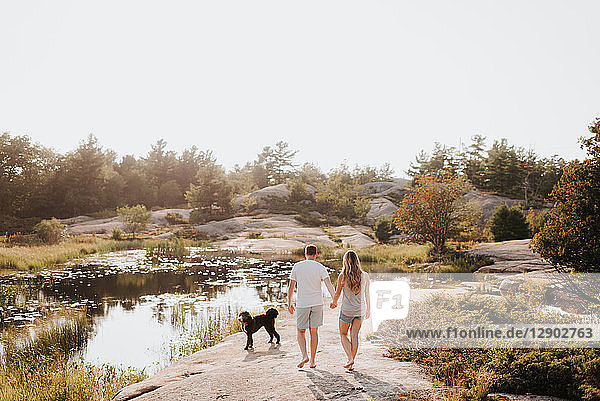 Couple walking with pet dog  Algonquin Park  Canada