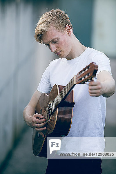Young musician playing guitar