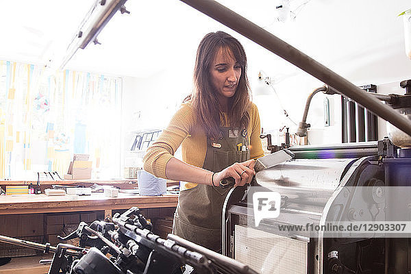 Woman preparing printer in shop