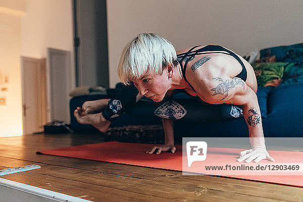Woman practising yoga at home