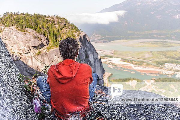 Rock climber relaxing at top of rock  Squamish  Canada