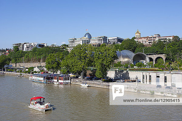 Georgia  Tbilisi  Boats on Kura river with presidential palace in background