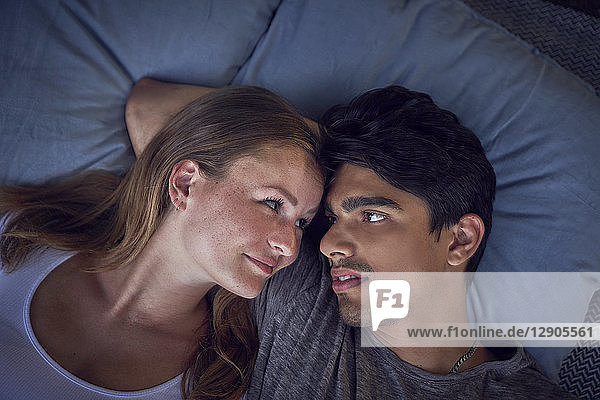 Young couple relaxing on cushions