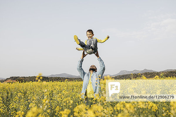 Spain  father and little son having fun together in a rape field